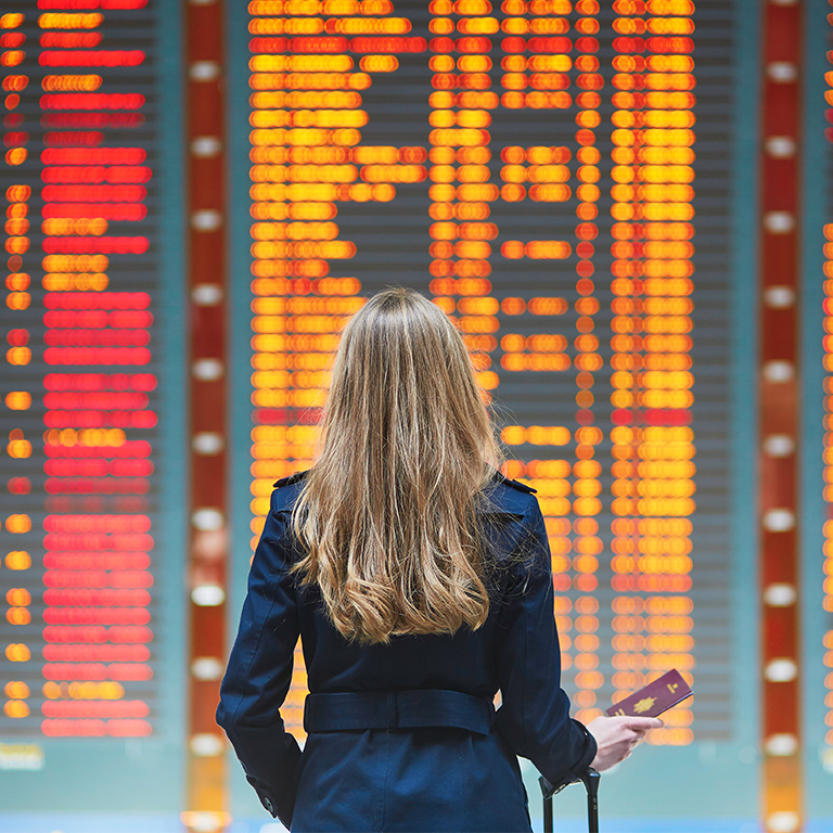 woman looking at flight board