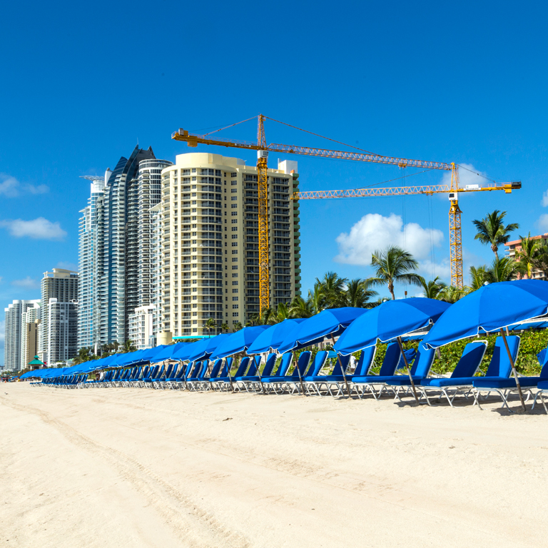 blue beach chairs and umbrellas on Sunny Isles Beach